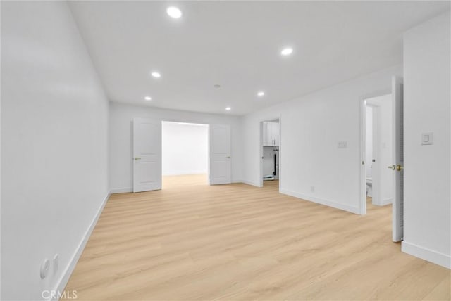 empty room with light hardwood / wood-style flooring