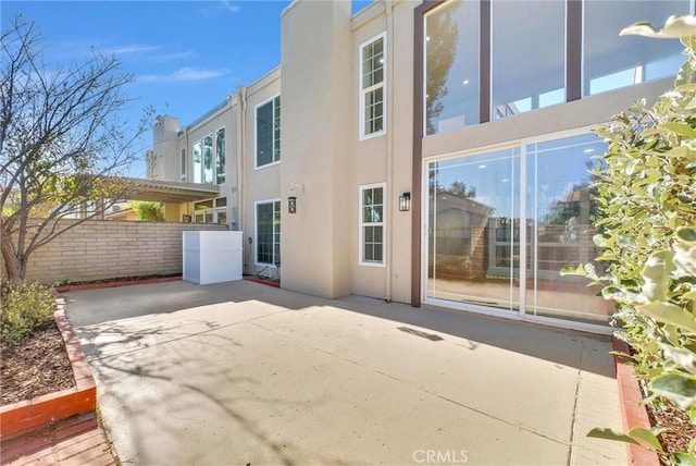 view of side of home featuring a patio