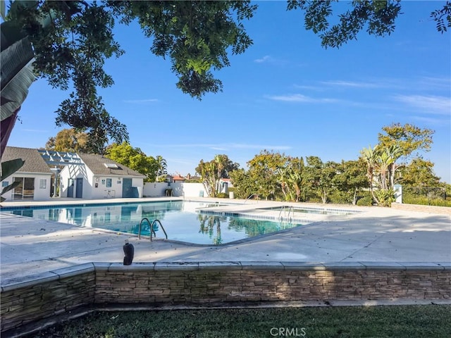 view of swimming pool with a patio area