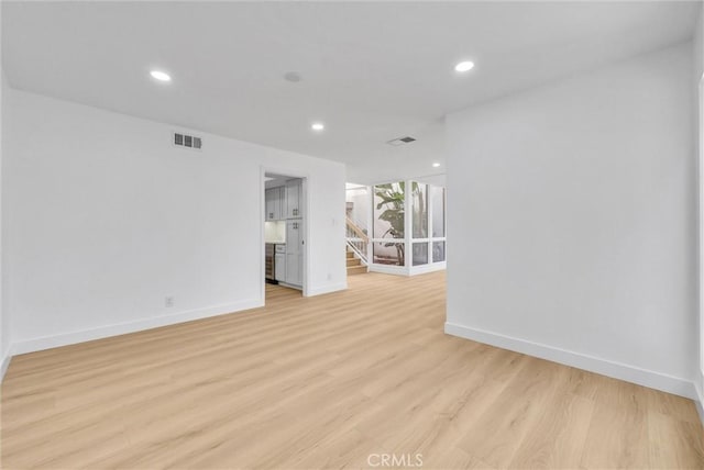 spare room with light hardwood / wood-style flooring