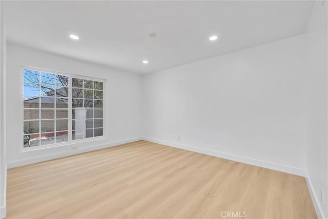 empty room with light hardwood / wood-style flooring