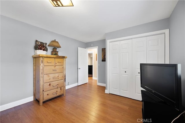 bedroom with hardwood / wood-style floors and a closet