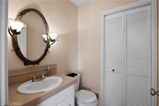 bathroom featuring toilet and vanity