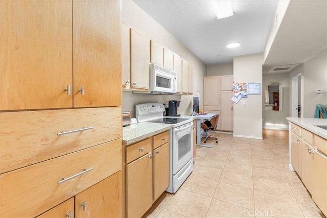 kitchen featuring light tile patterned floors and white appliances