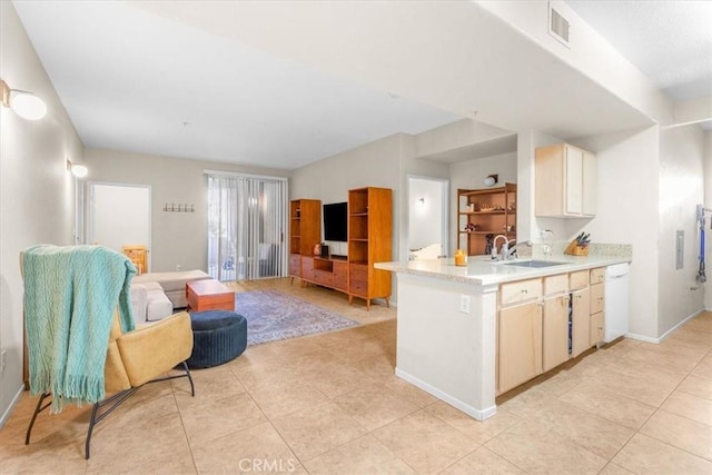 kitchen with white dishwasher, sink, and light tile patterned floors