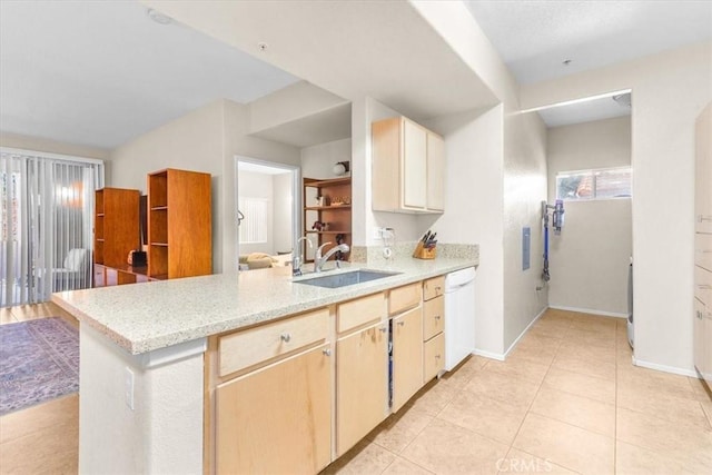 kitchen with light brown cabinetry, dishwasher, kitchen peninsula, and sink