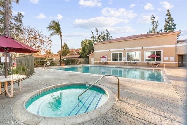 view of pool featuring a patio area and a hot tub