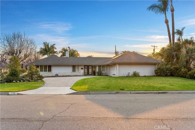 ranch-style home with a front yard