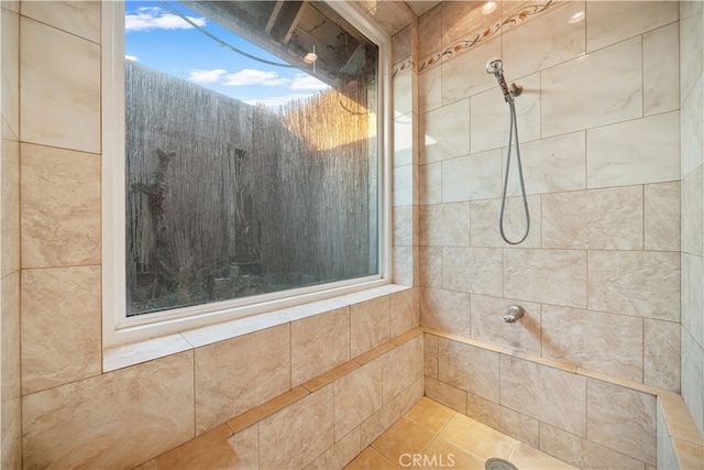 bathroom with a tile shower