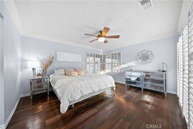 bedroom with ceiling fan, dark hardwood / wood-style flooring, crown molding, and a textured ceiling