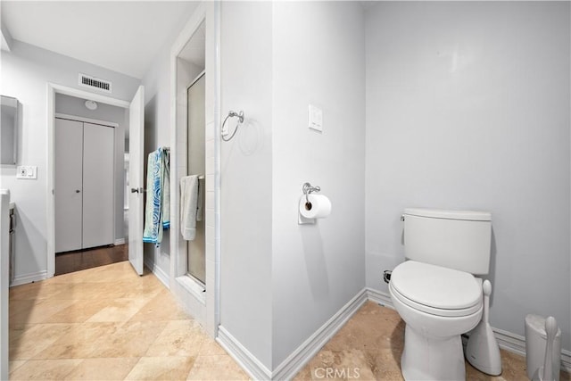 bathroom with vanity, toilet, and an enclosed shower