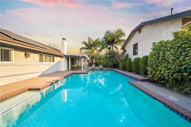 view of pool at dusk