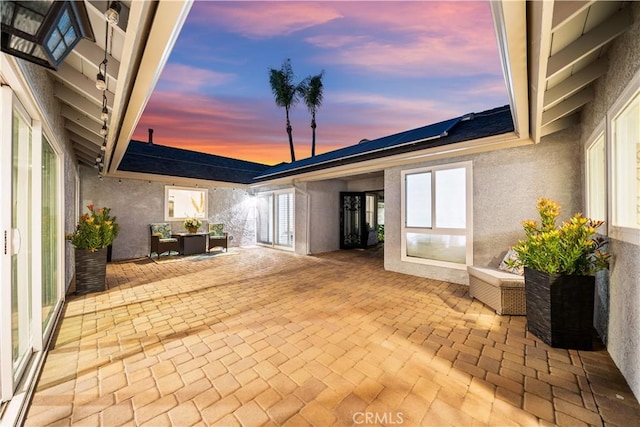 view of patio terrace at dusk