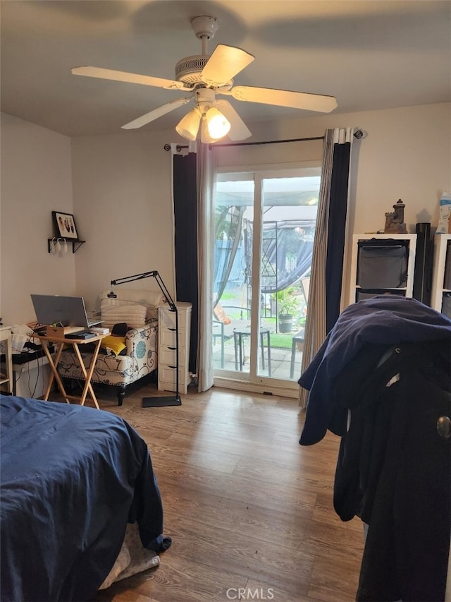 bedroom with ceiling fan, access to exterior, and wood-type flooring