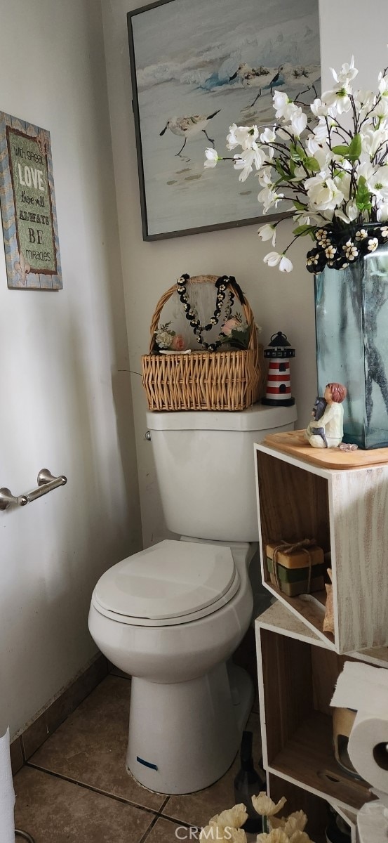 bathroom with toilet and tile patterned flooring