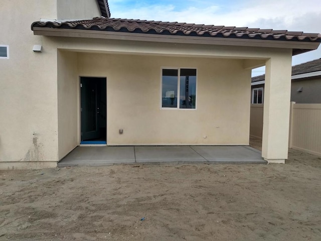 back of property with a patio