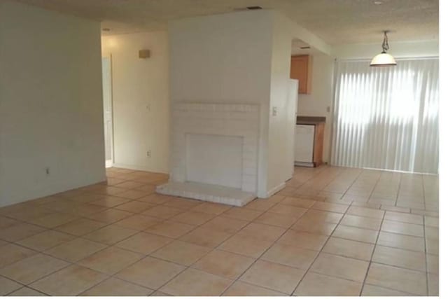 tiled spare room with a fireplace