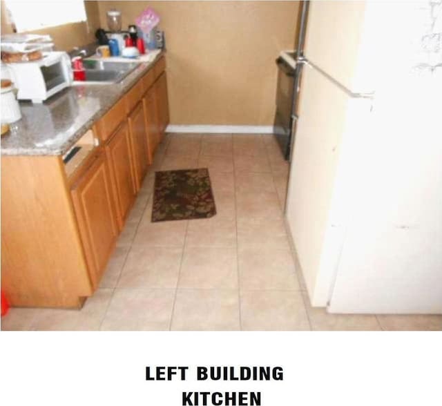 bathroom with sink and tile patterned flooring