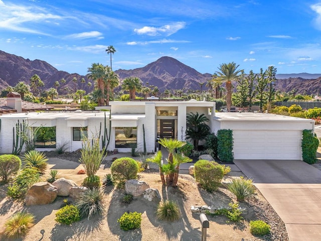 contemporary home with a mountain view and a garage