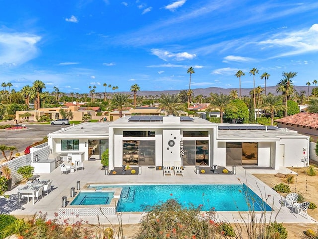 view of swimming pool with a patio area and a mountain view