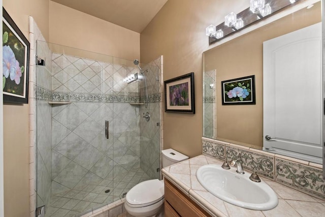 bathroom featuring vanity, a shower stall, and toilet