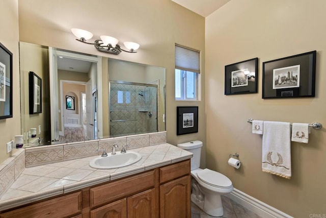 full bathroom featuring a stall shower, baseboards, toilet, tile patterned floors, and vanity