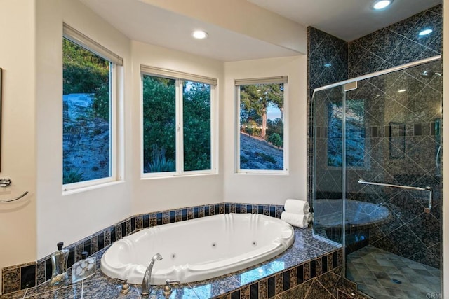 bathroom with a whirlpool tub, a stall shower, and recessed lighting