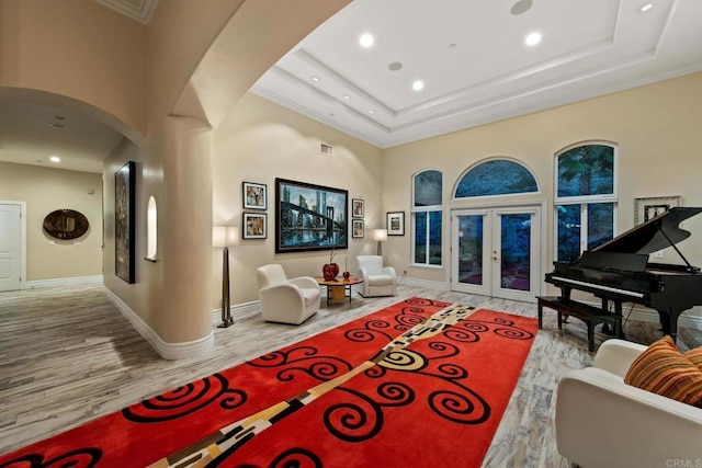 interior space with arched walkways, french doors, wood finished floors, and recessed lighting