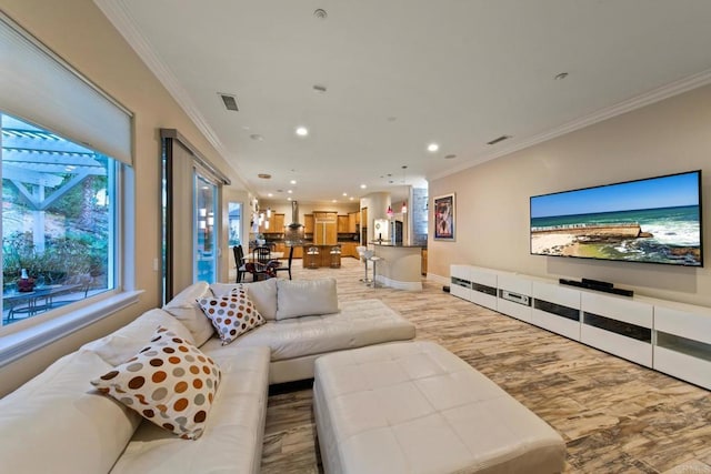 living room with ornamental molding, light wood-type flooring, visible vents, and recessed lighting