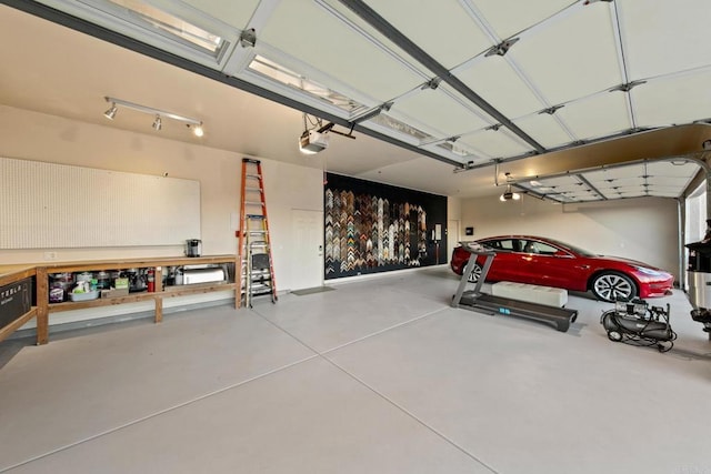 246 Yucca, Fallbrook, CA 92028 - garage featuring a garage door opener and a workshop area