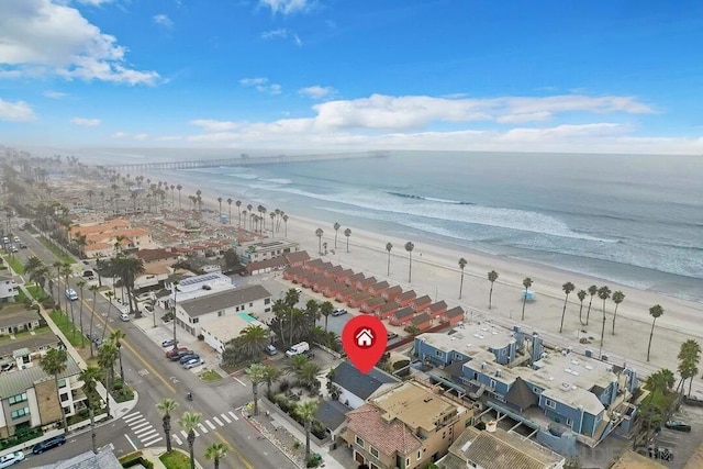 birds eye view of property with a view of the beach and a water view