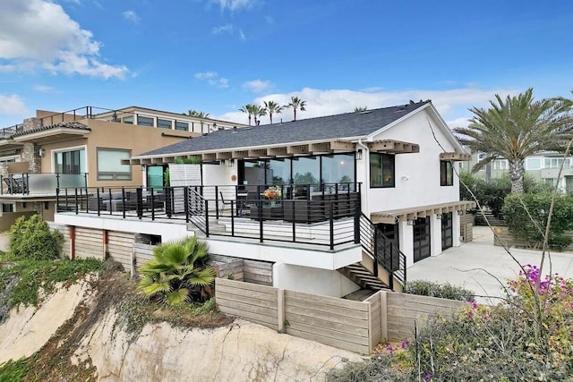 rear view of property featuring a garage