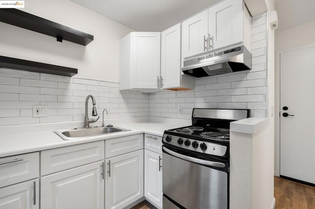 kitchen with stainless steel range oven, dark wood-type flooring, white cabinetry, decorative backsplash, and sink