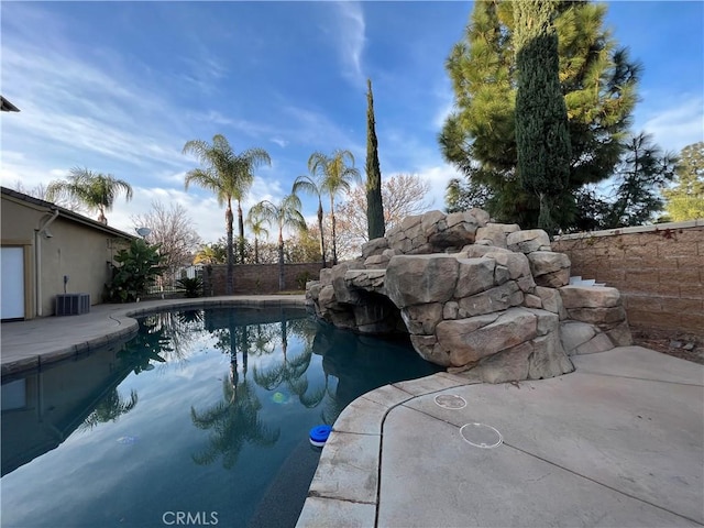 view of swimming pool with central AC unit