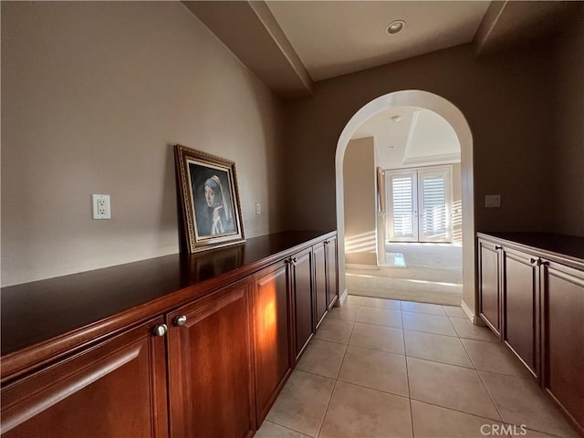 corridor featuring light tile patterned flooring