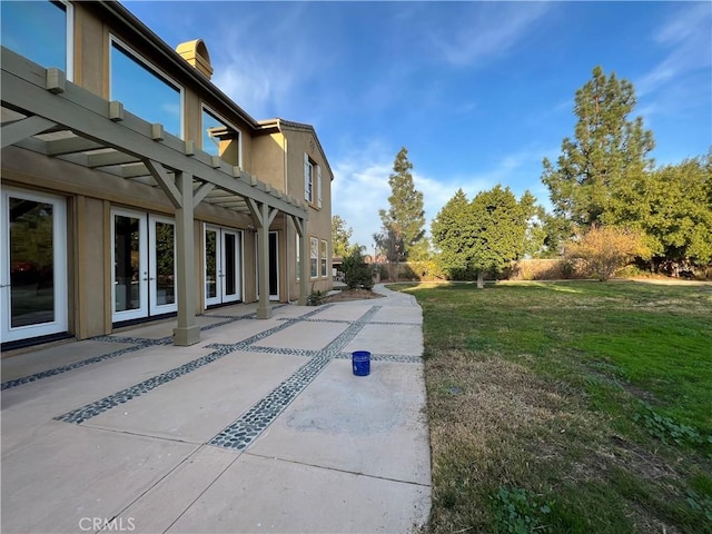 view of yard with french doors and a patio