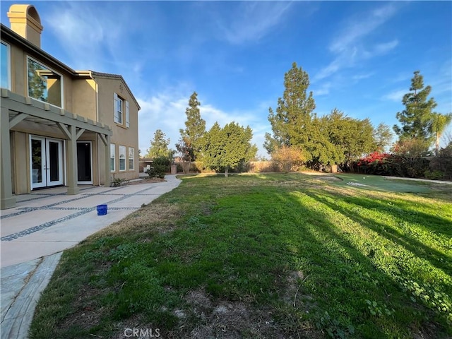 view of yard with a patio area and french doors