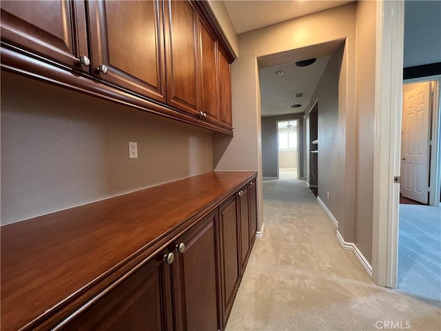 hallway featuring light carpet