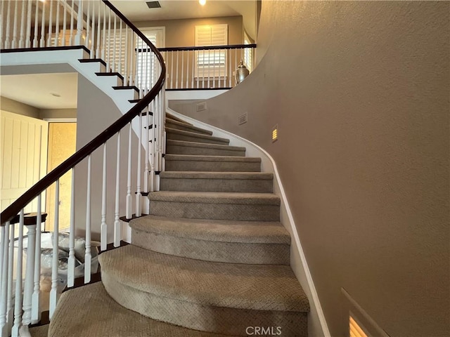 staircase featuring plenty of natural light