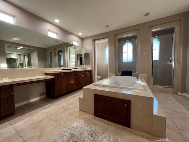 full bathroom with toilet, vanity, tile patterned flooring, and plus walk in shower