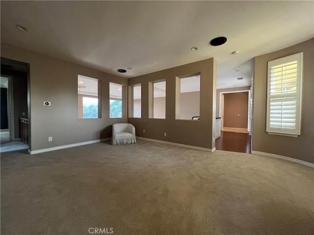 interior space with a healthy amount of sunlight and dark colored carpet