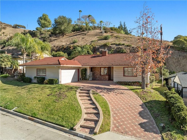 view of front of home with a garage and a front yard