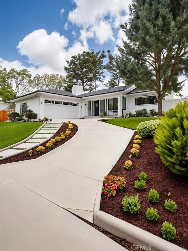 view of front of home with a front lawn and a garage