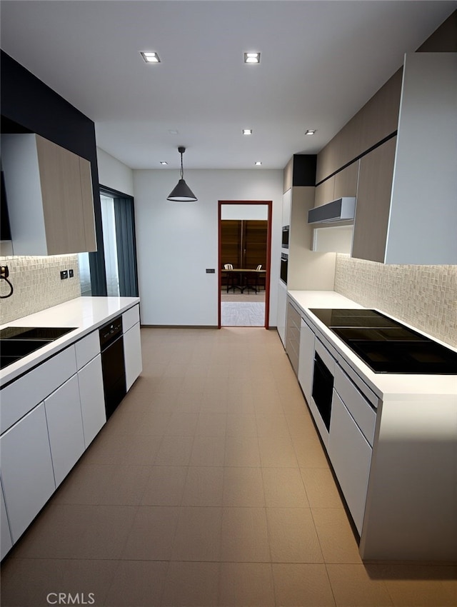 kitchen with white cabinets, black appliances, tasteful backsplash, sink, and hanging light fixtures