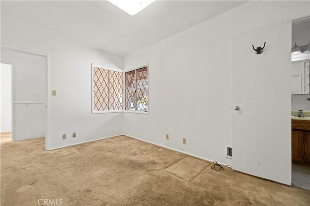 unfurnished room with sink and carpet