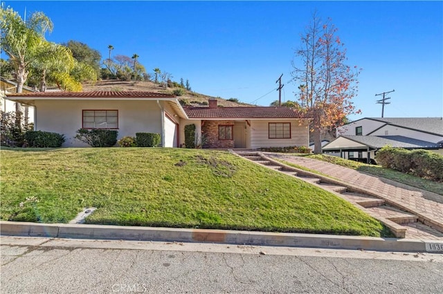 single story home featuring a front lawn