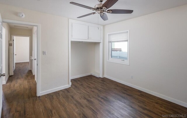 unfurnished bedroom with ceiling fan, a closet, and dark hardwood / wood-style flooring