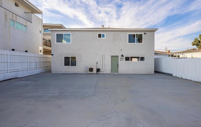 rear view of house featuring ac unit and a patio