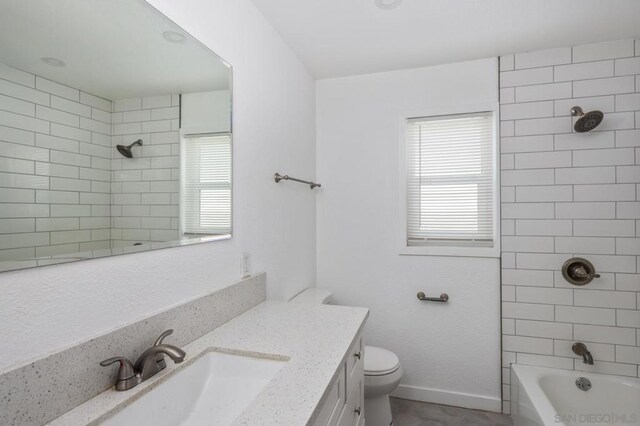 full bathroom with toilet, vanity, tiled shower / bath combo, and a wealth of natural light