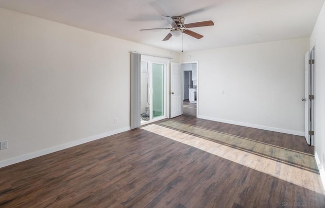 empty room featuring ceiling fan and dark hardwood / wood-style flooring